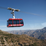 A red tram moving over Copper Canyon, Mexico.